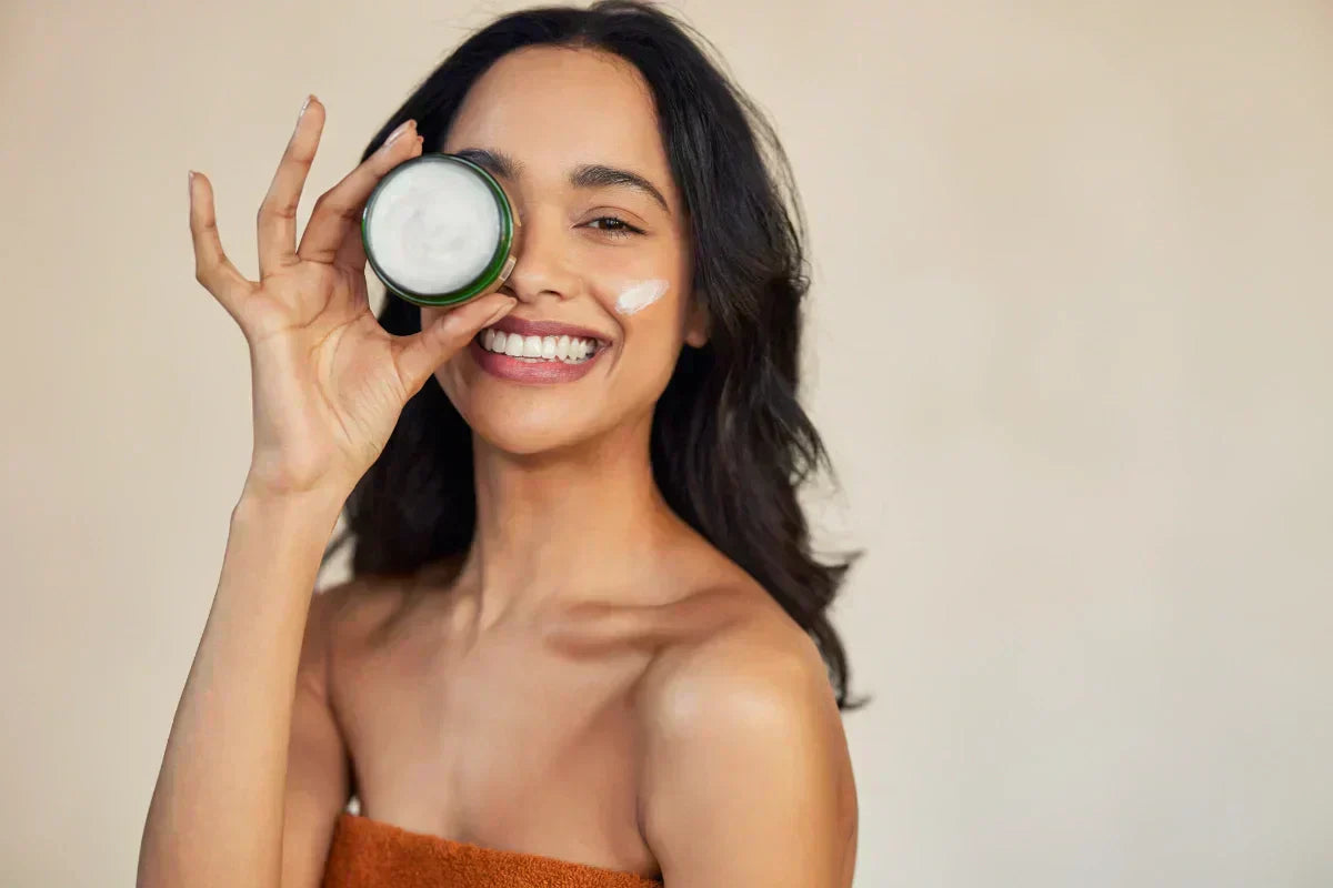 Happy woman showcasing her favorite retinol moisturizer cream