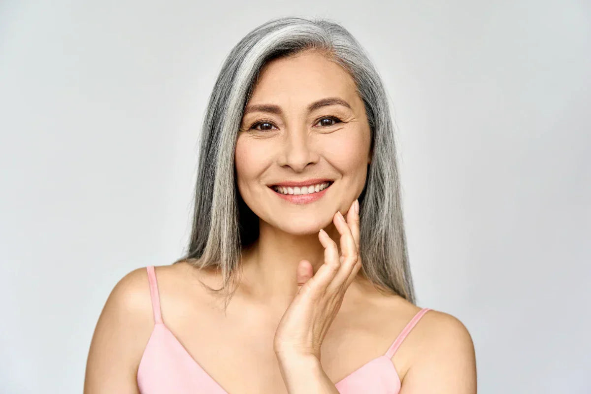 Happy mature woman with smooth skin after using retinaldehyde skincare