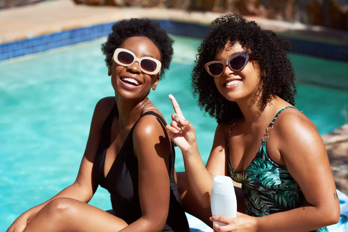 Two women enjoying sun protection with mineral sunscreen