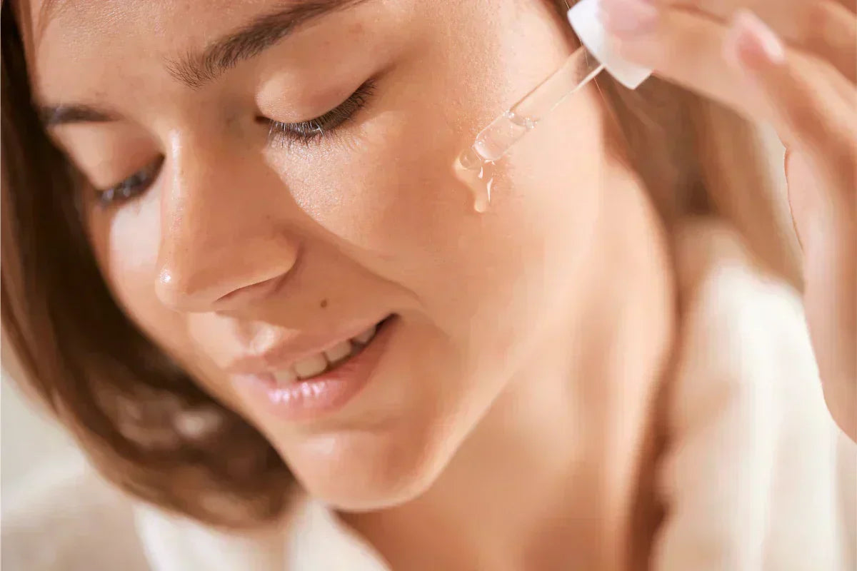 Woman applying hydrating facial serum for glowing, moisturized skin