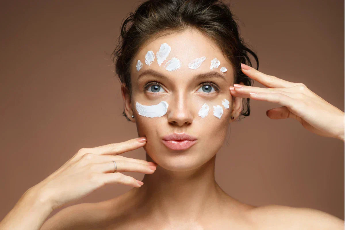 Applying salicylic acid cream on face using dot method to treat acne, unclog pores, and improve skin texture safely