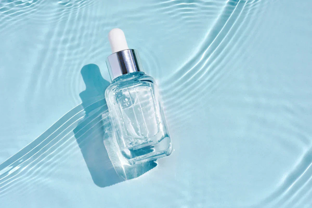 Cooling skincare serum bottle in water representing menthyl lactate freshness