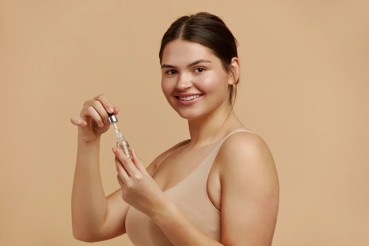 Woman holding dropper bottle of Alpha Arbutin serum, showcasing a safe skin-brightening solution