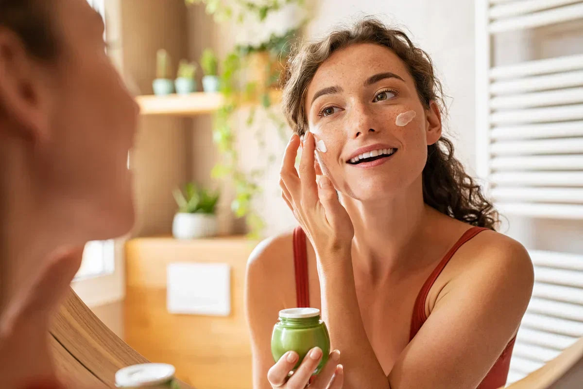 Young woman with healthy glowing skin demonstrating a barrier-friendly anti-aging skincare routine with Bakuchiol-based cosmetic formulations. 