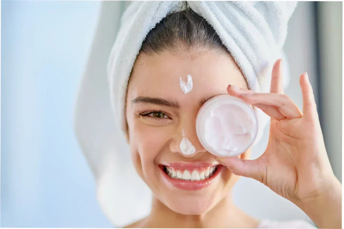 Woman applying moisturizer for clearer, hydrated skin